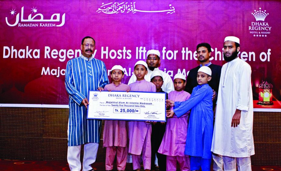 Executive Director of Dhaka Regency Hotel and Resort Shahid Hamid FIH handing over a cheque of Tk 25,000 to the Principal of Majahirul Ulum Al-Islamia Madrasha in the city recently.