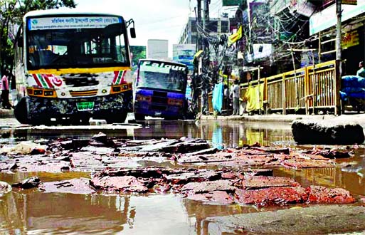 Dilapidated condition of city's busy road in front of Mouchak Market. This photo was taken on Sunday.