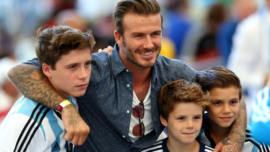 Former England international David Beckham and sons Brooklyn Beckham (L), Cruz Beckham (2nd R) and Romeo Beckham (R) prior to the 2014 FIFA World Cup Brazil final match between Germany and Argentina at Maracana in Rio de Janeiro, Brazil on Sunday.