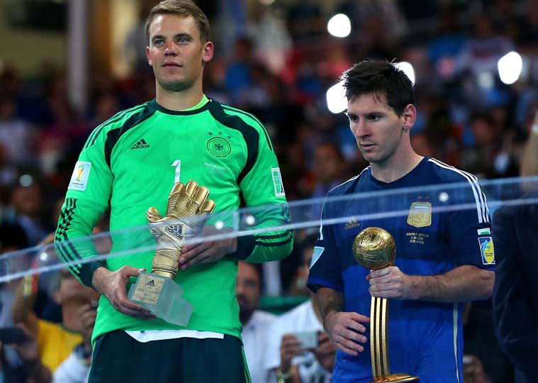 Manuel Neuer of Germany receives the Golden Glove trophy and Lionel Messi of Argentina receives the Golden Ball during the award ceremony after the 2014 FIFA World Cup Brazil final match between Germany and Argentina at Maracana in Rio de Janeiro, Brazil