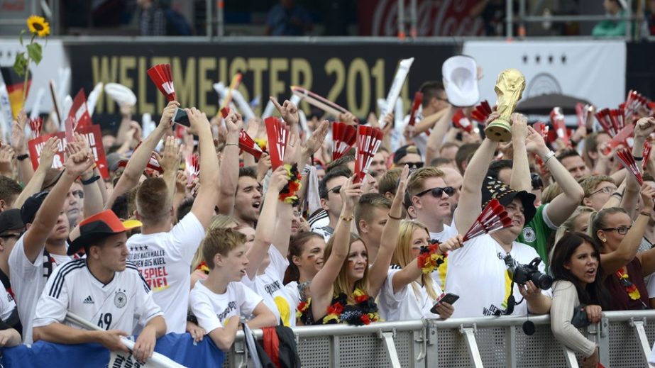 German fans wait in front of a stage installed for a victory parade of Germany's national football team on Tuesday at Berlin's landmark Brandenburg Gate to celebrate their FIFA World Cup title. Germany won their fourth World Cup title, after 1-0 win ove