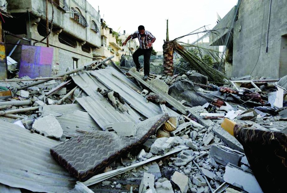 A Palestinian walks on the rubble from a damaged house following fresh Israeli missile strike in Gaza City on Tuesday after a brief six hour cease-fire. : Internet photo