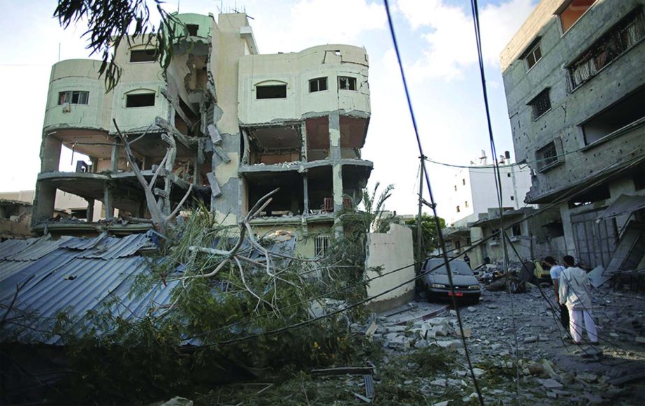 Palestinians inspect the damage to the house of Hamas leader, Mahmoud Zahar, following an early morning Israeli missile strike in Gaza City.