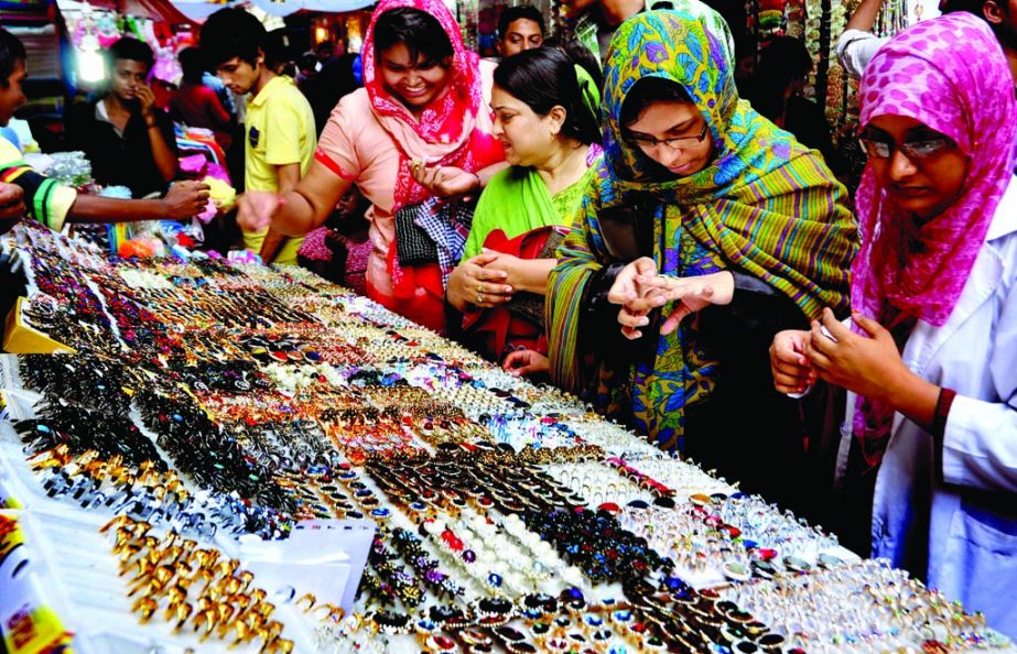 Female buyers making their choices to different ornaments ahead of Eid-ul-Fitr. The snap was taken from an imitation ornaments shop of Mouchak Market in the city on Thursday.