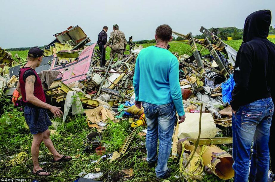 Ukrainians inspect the wreckage of MH17 as coal miners, farmers and other volunteers help with the grisly task of clearing up the crash sites after the Malaysian Airlines jet was shot down by a surface-to-air missile over the east of the country.