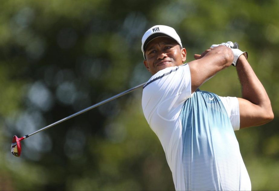 Tiger Woods of the US plays a shot off the 8th tee during the first day of the British Open Golf championship at the Royal Liverpool golf club in Hoylake, England on Thursday.