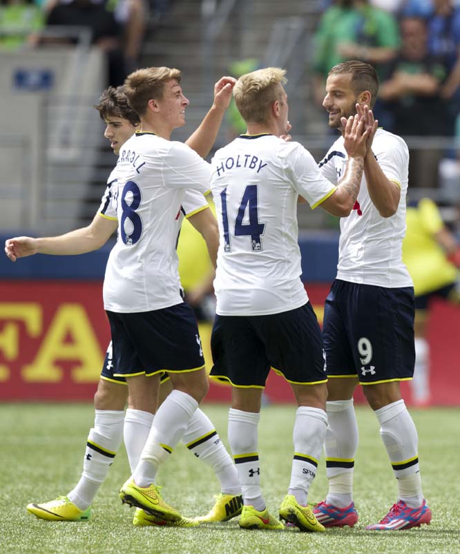 Tottenham Hotspur's Roberto Soldado (9) is congratulated by teammates Tom Carroll (second from left) and Lewis Holtby (14) after Soldado scored on a penalty kick against the Seattle Sounders during a friendly soccer match in Seattle on Saturday. The matc
