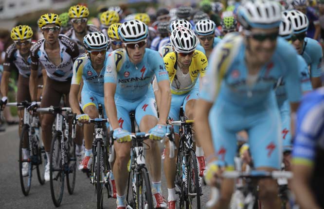 Italy's Vincenzo Nibali, wearing the overall leader's yellow jersey, rides in the pack during the fourteenth stage of the Tour de France cycling race over 177 kilometers (110 miles) with start in Grenoble and finish in Risoul, France on Saturday.