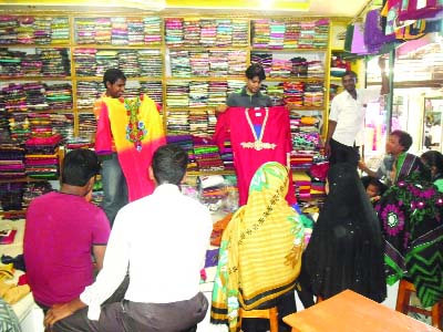 THAKURGAON: Customers shopping sarees at a store on the occasion of Eid-ul-Fitr.