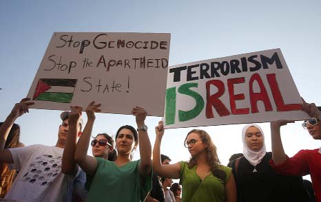 Lebanese and Palestinians hold up placards during a protest against the war in Gaza, in Beirut, Lebanon.