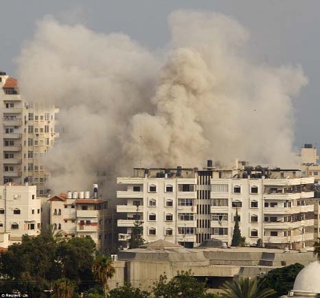 Smoke rises following Israeli air strikes in Gaza City on Tuesday