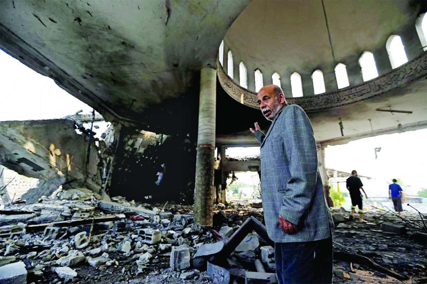 A Palestinian walks inside the Al Aqsa Martyrs mosque destroyed by an overnight Israeli strike, in Gaza City on Tuesday.