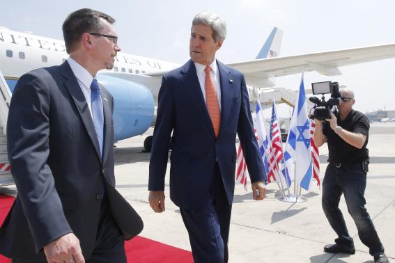 U.S. Secretary of State John Kerry talks with U.S. Embassy Deputy Chief of Mission Bill Grant as he arrives in Tel Aviv, July 23, 2014. Credit: ReutersCharles DharapakPool