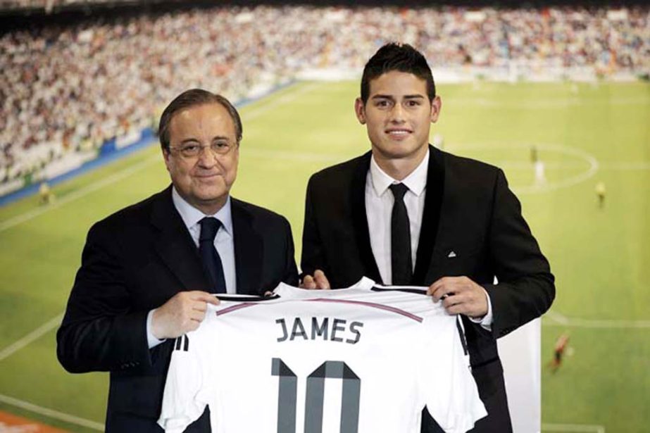 Real Madrid president Florentino Perez (left) and new Real Madrid player James Rodriguez, from Colombia, hold his new shirt and poses for photographers during his official presentation at the Santiago Bernabeu stadium in Madrid, Spain on Tuesday after sig