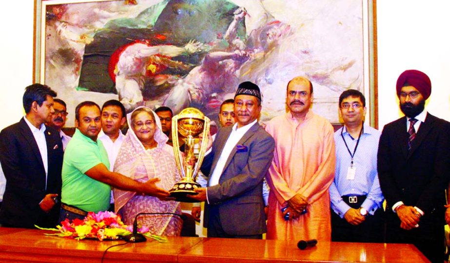 Prime Minister Sheikh Hasina and BCB President Nazmul Hasan Papon along with others pose for photo with the World Cup Cricket Trophy at the Prime Minister's official Ganobhaban on Friday.