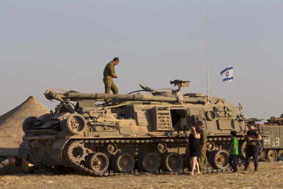 An Israeli soldier stands on top of a military vehicle in a base near Sa'ad in the southern district of Israel, July 26, 2014. CREDIT: REUTERSSIEGFRIED MODOLA