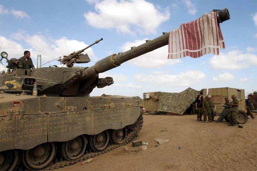 Israeli soldiers rest at an army deployment area along the Israeli border with the Gaza Strip on Sunday.