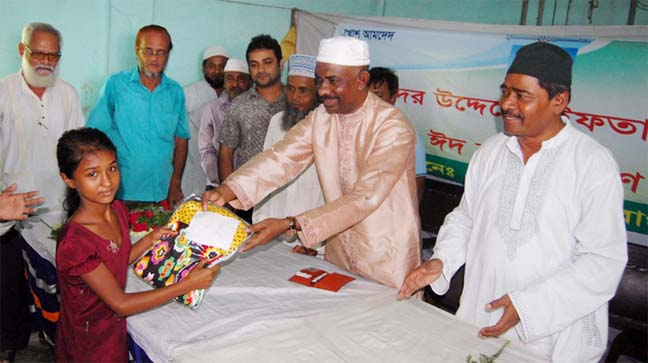 Panel Mayor Chowdhury Hasan Mohammad Hasni distributing Eid clothes among the street children in Chittagong yesterday.