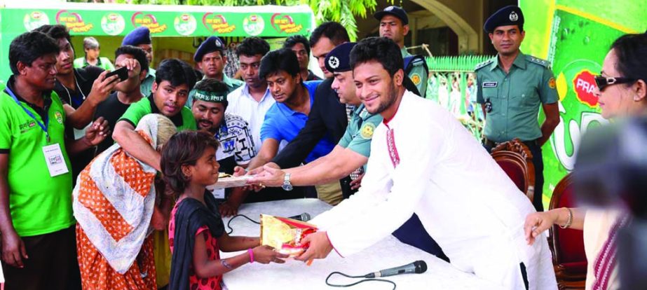 Shakib Al Hasan distributed clothes among underprivileged people at the Kamalapur Railway Station in the city recently.