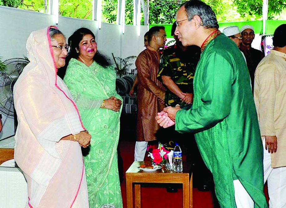 Prime Minister Sheikh Hasina exchanging pleasantries with guests on the occasion of Eid-ul-Fitr at Ganobhaban on Tuesday. PID photo
