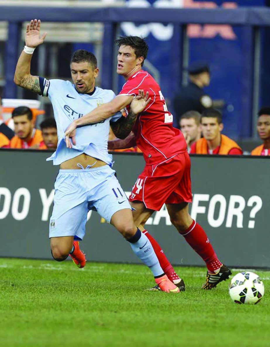 Liverpool's Martin Kelly (34) and Manchester City's Aleksandar Kolarov (11) fight for the ball in the first half of a Guinness International Champions Cup soccer tournament match in New York on Wednesday.