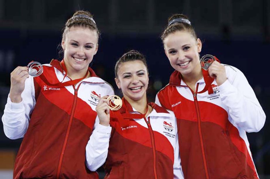 Ruby Harold with silver (left) Claudia Fragapane with gold (centre) and Hannah Whelan with bronze (right) all of England hold up their medals after the Women's All-Around gymnastics competition at the Scottish Exhibition Conference Centre during the Comm