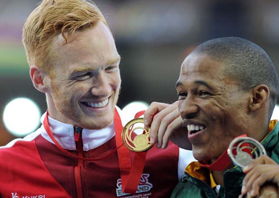 England's Greg Rutherford (left) celebrates with his gold medal alongside bronze medallist South Africa's Rushwahl Samaai after the men's long jump at Hampden Park, during the 2014 Commonwealth Games in Glasgow, Scotland on Wednesday.