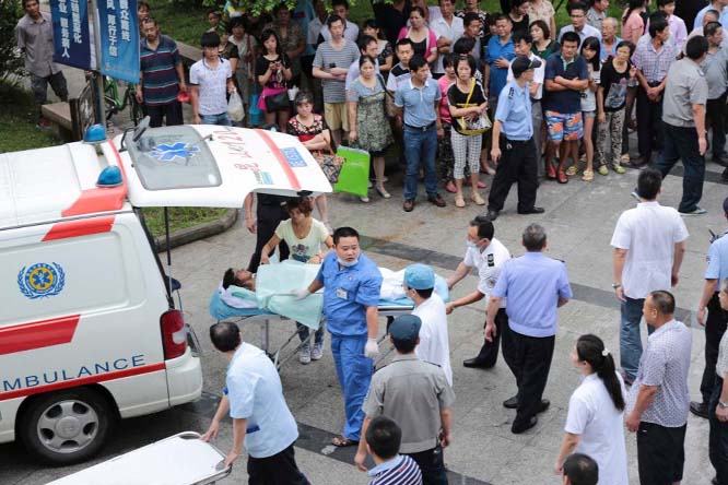 Medical personnel transport a victim to a hospital after an explosion at a factory in Kunshan, Jiangsu province.