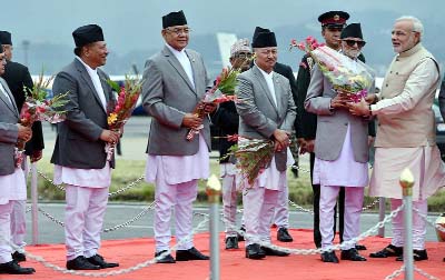 Prime Minister Narendra Modi being welcomed by Nepalese Prime Minister Sushil Koirala (2L) on his arrival at Tribhuvan International Airport in Kathmandu.