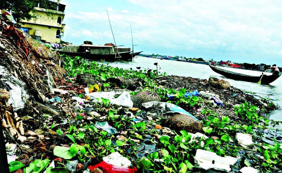 Despite repeated calls for social awareness and warnings from various authorities to restore the Buriganga River from the grabbers, dumping of garbages into Buriganga River is a regular feature. This photo was taken from Sadarghat area on Sunday.