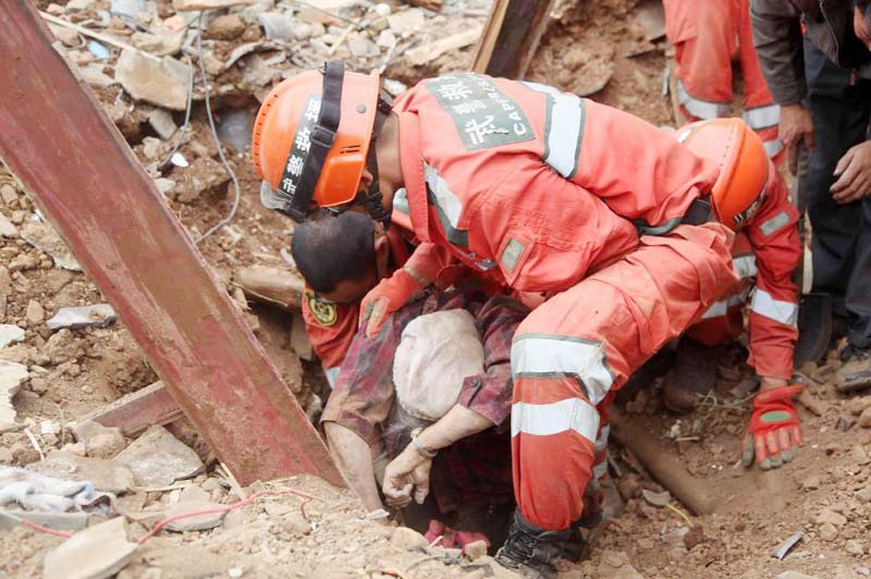 Rescuers pull a survivor from debris after an earthquake hit Ludian county in Zhaotong, China's Yunnan province on Monday, killing over 400 people and injuring more than 1,400, according to China's official Xinhua News Agency.