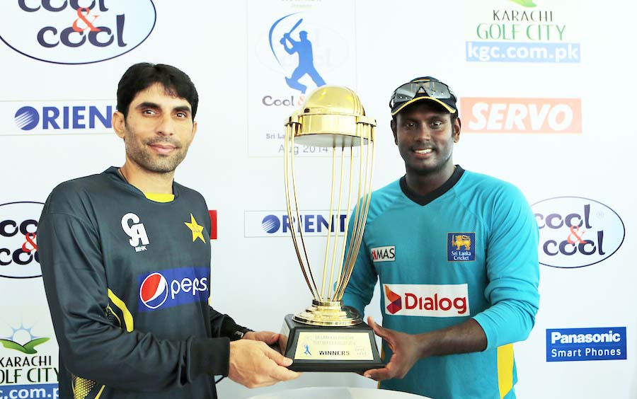 Misbah-ul-Haq (left) and Angelo Mathews pose with the trophy at Galle on Tuesday.