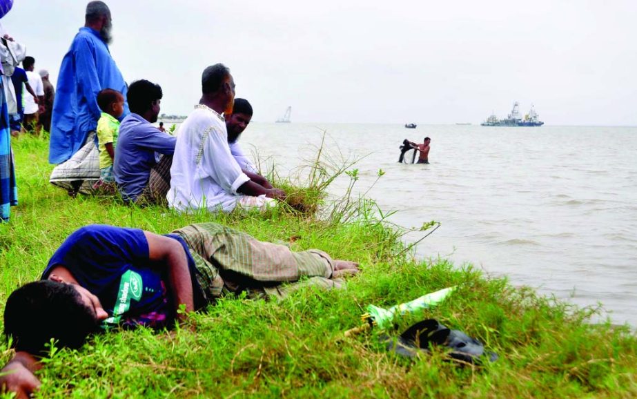 Relatives of the victims of ill-fated launch capsized in Padma River have been awaiting for the bodies of their near and dear ones on the bank of the mighty river.