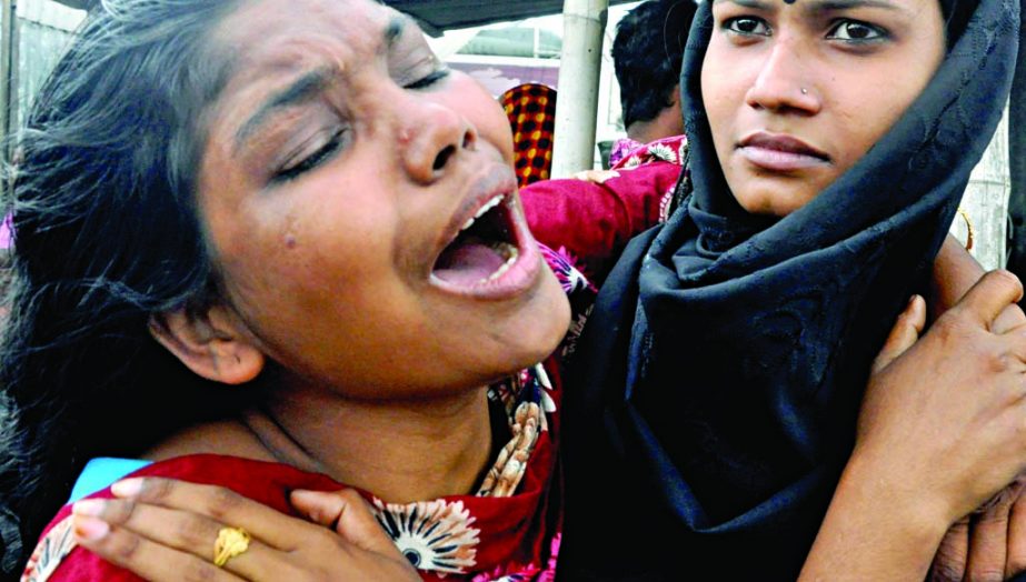 Relatives mourning the deaths of the victims of the ill-fated launch capsized in Padma River on Monday. This photo was taken from the Mawa Ghat site on Tuesday.