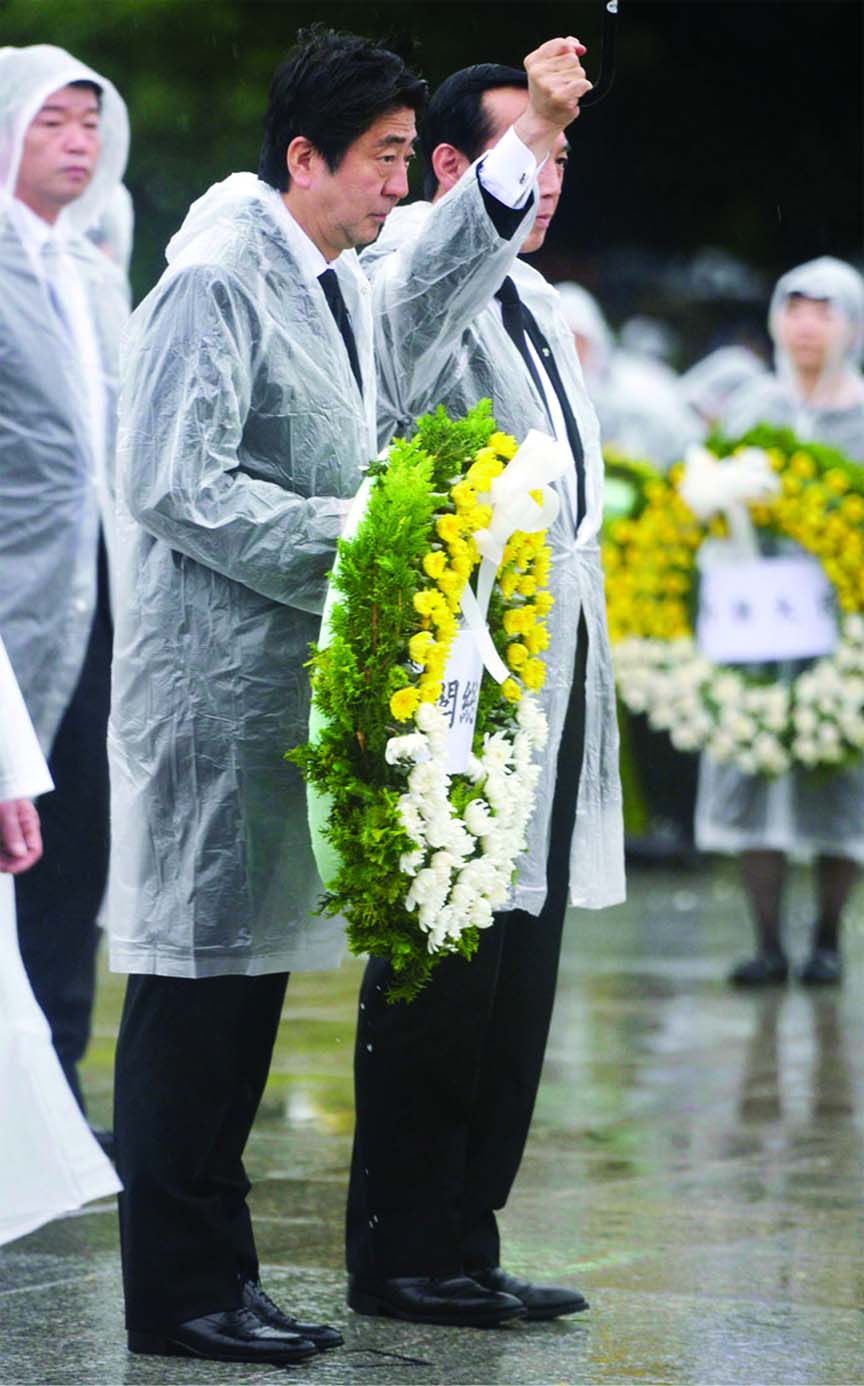 Japan's Prime Minister Shinzo Abe offers a flower wreath for the victims of the 1945 atomic bombing.