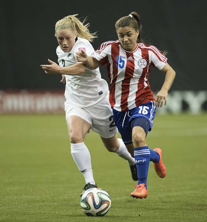 New Zealand's Catherine Bott (left) and Paraguay's Veronica Kurtz battle for the ball during the first half of a 2014 FIFA U-20 women's World Cup soccer game in Montreal on Wednesday.