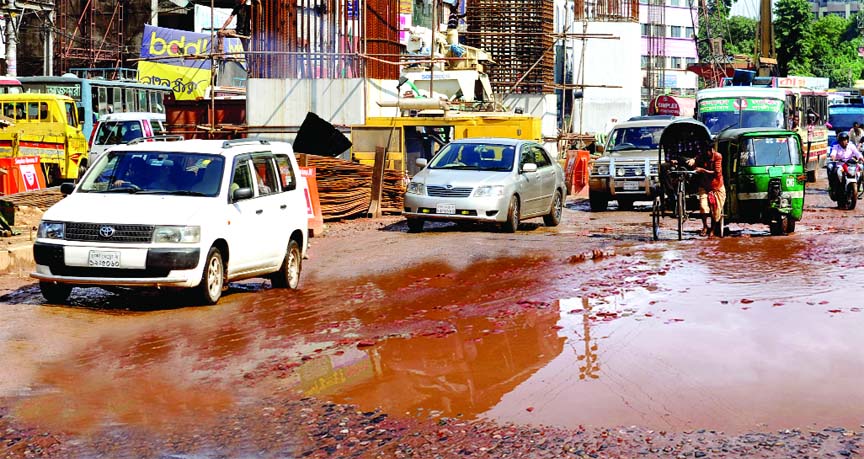 This busy thoroughfare at city's Moghbazar area is now in pitiable condition amid a little spell of rain causing suffering to commuters and dwellers. This snap was taken on Thursday.