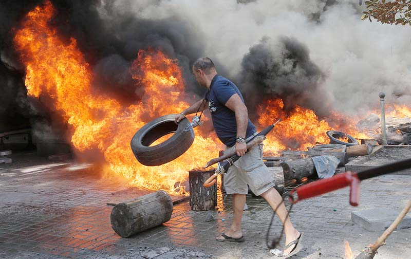 An activist burns tyres during a clash with a special forces police battalion, in Independence Square, Kiev, Ukraine.