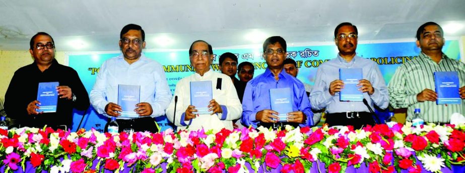 Political Adviser to Prime Minister HT Imam along with other distinguished guests holds the copies of a book titled 'Police and Community with Concept of Community Policing' at its cover unwrapping ceremony at Rajarbagh Police Auditorium in the city on