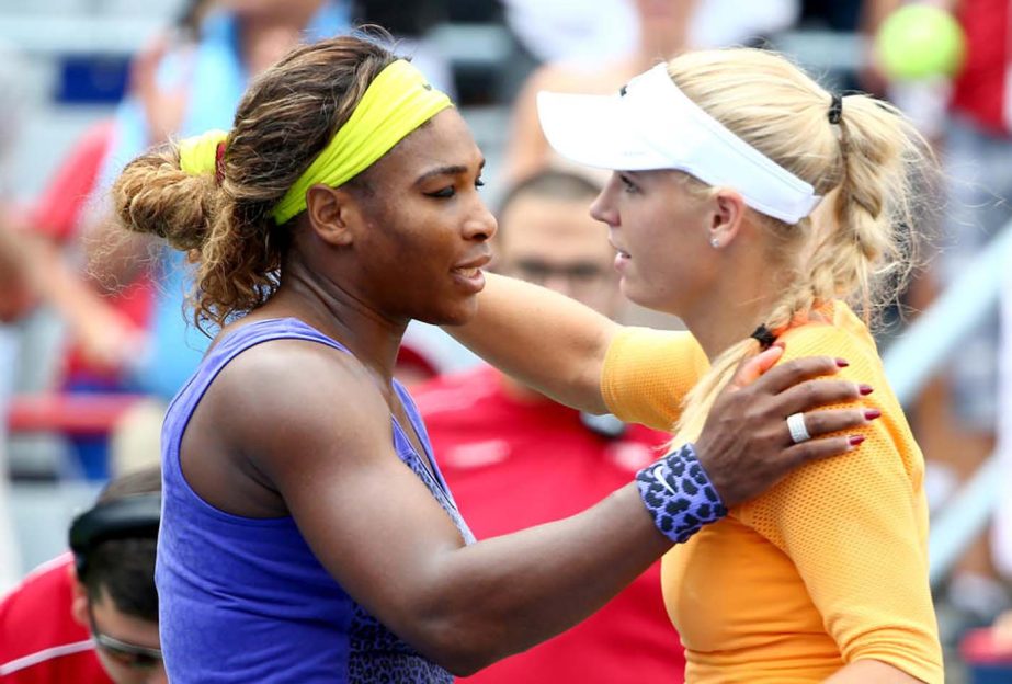 Serena Williams (L) hugs Caroline Wozniacki after their Rogers Cup match in Montreal on Friday.