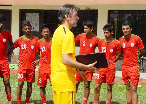 Head Coach of Bangladesh National Football team Lodewijk Darius De Kruif giving instructions to the members of Bangladesh under-23 National Football team during the practice session at the BKSP Ground in Savar on Saturday.