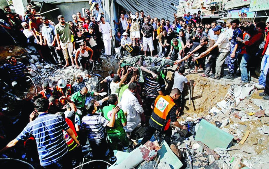 Palestinians remove the body from under the rubble of al-Qassam Mosque in Nuseirat refugee camp, central Gaza Strip, after it was hit again by an Israeli airstrike. Internet