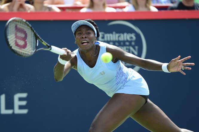 Venus Williams returns to her sister Serena Williams during semifinal play at the Rogers Cup tennis tournament in Montreal on Saturday.