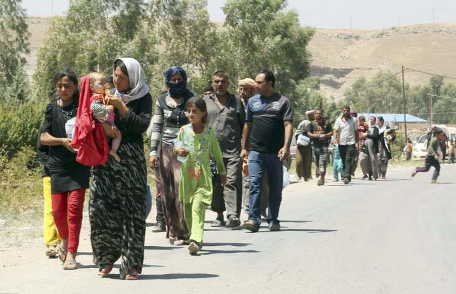 Displaced Iraqis from the Yazidi community cross the Syria-Iraq border at Feeshkhabour border point in northern Iraq.