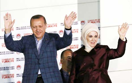 Turkey's Prime Minister Tayyip Erdogan and wife Ermine wave hands to supporters as they celebrate his election victory in front of the party headquarters in Ankara.