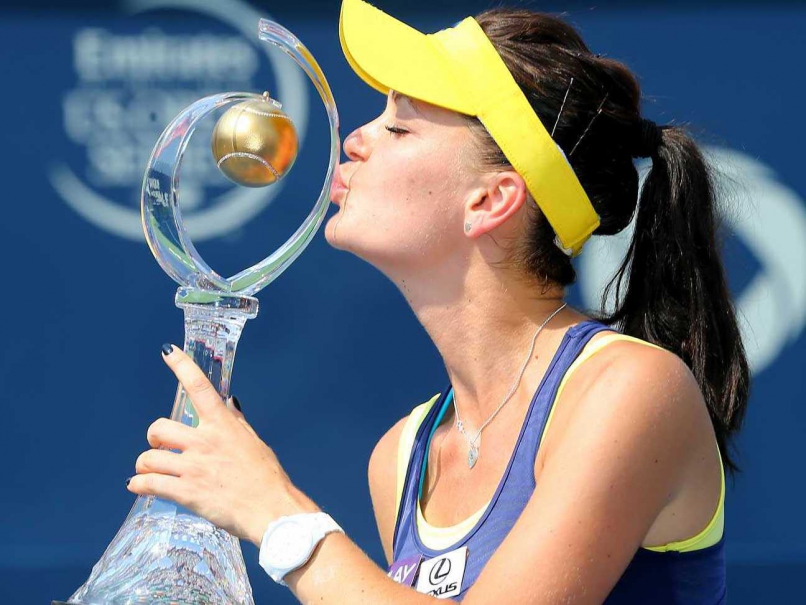 Agnieszka Radwanska of Poland kisses the winner's trophy after beating Venus Williams of the United States (not seen) in the final at the Rogers Cup tennis tournament in Montreal on Sunday.
