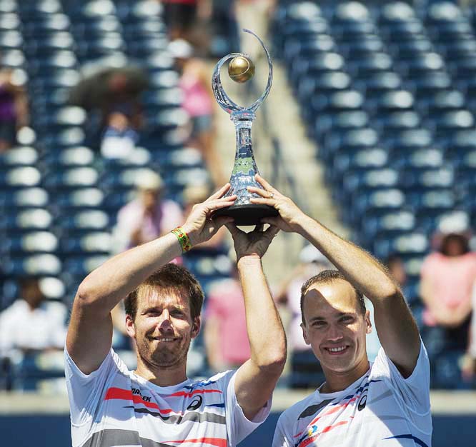 Alexander Peya of Austria (left) holds up the doubles trophy with his partner Bruno Soares of Brazil during the Rogers Cup tennis tournament men's doubles final in Toronto on Sunday.