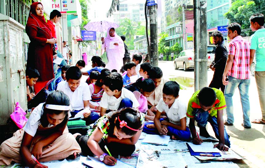 Students of a demolished govt primary school situated at city's Bailey Road appeared at the examination under open sky on Tuesday.