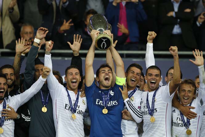 Real Madridâ€™s goalkeeper Iker Casillas lifts the trophy with teammates after winning the UEFA Super Cup soccer match between Real Madrid and Sevilla in Cardiff City Stadium in Cardiff, Wales on Tuesday.