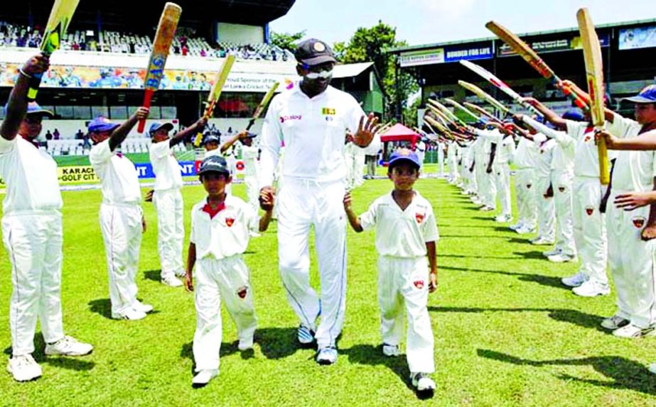 Sri Lankan cricketer Mahela Jayawardene receives a guard of honour by young cricketers during the second day of the second test cricket match between Sri Lanka and Pakistan in Colombo, Sri Lanka on Friday. Former captain Jayawardene is playing his 149th a